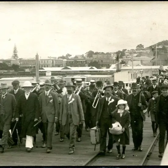 Brass Band marching on Albany Jetty with large ...